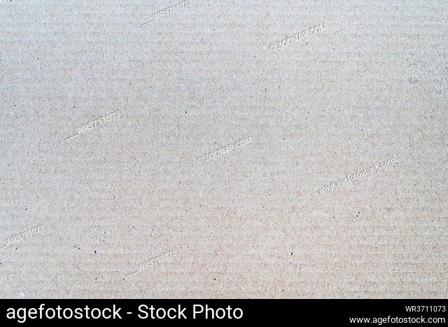 Background from sheet of recycled cardboard. Close-up detail macrography view of light gray abstract texture recycled eco-friendly carton material pattern...