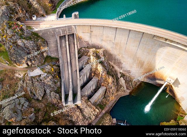 Aerial drone footage top view Water dam and reservoir lake, generating hydro electricity power renewable energy and sustainable development