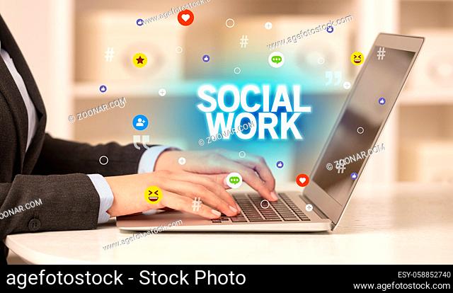 Freelance woman using laptop with SOCIAL WORK inscription, Social media concept
