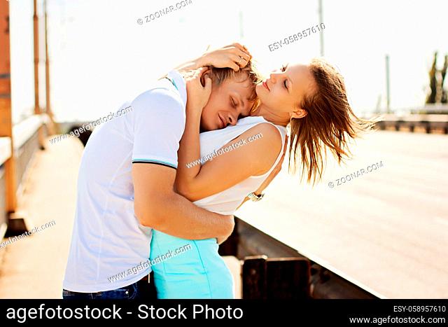 Man and woman kissing and embracing on the bridge. Couple in love