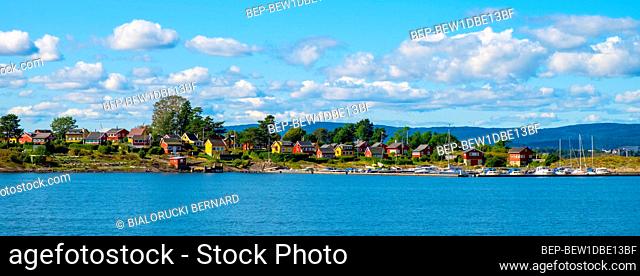 Oslo, Ostlandet / Norway - 2019/09/02: Panoramic view of Nakholmen island on Oslofjord harbor with marina and summer cabin houses at shoreline in early autumn