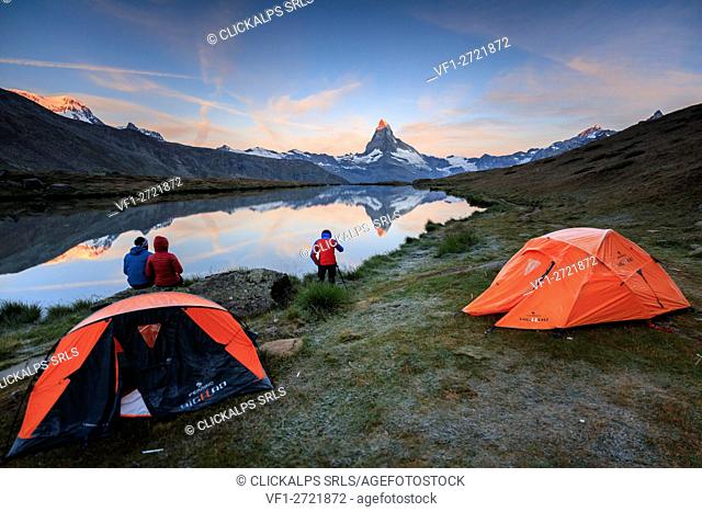 Photographer in action with Matterhorn reflected in Lake Stellisee at dawn Zermatt Canton of Valais Switzerland Europe
