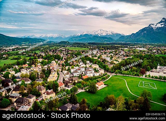Aerial perspective view on touristic city in the valley surrounded by meadows, forest and rapeseed fields