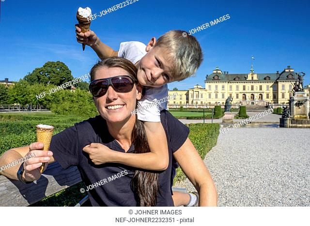 Happy mother and son having ice-cream