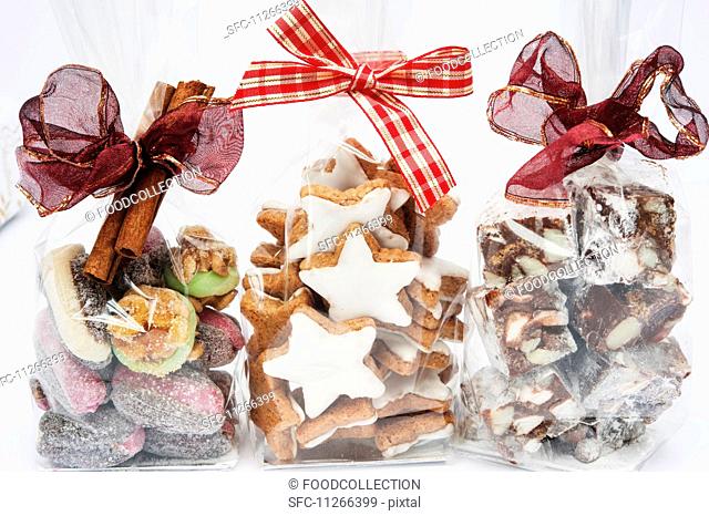Three cellophane bags of Christmas gifts (cinnamon stars, Rocky Road and dates with marzipan)