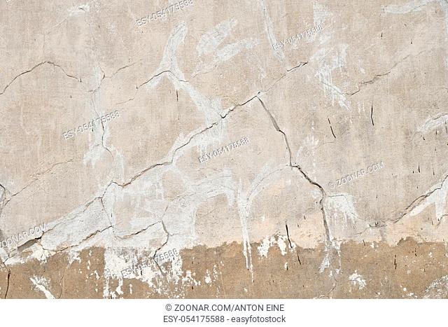 Background texture of old beige gray painted plaster wall with cracks and grunge repair stains