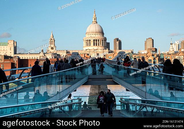 London, United Kingdom - December 8 2015: People walking at the Millennium bridge , officially known as the London Millennium Footbridge crossing river Thames...