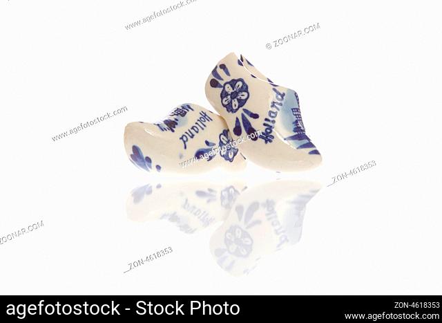 Dutch ceramic Delft Blue wooden shoes on a white background