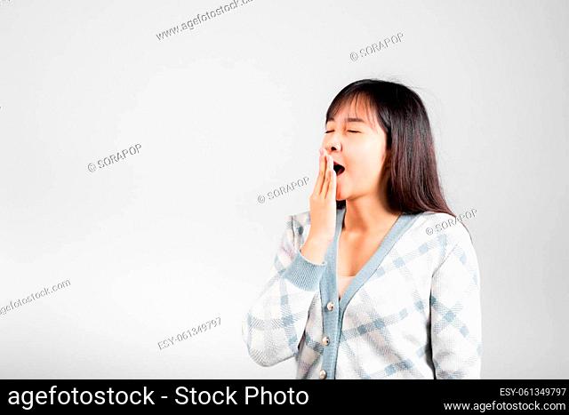 Sleepy woman closed eyes emotions tired and sleepy her yawning cover mouth open by hand, Portrait Asian beautiful young female sleep and energy studio shot...
