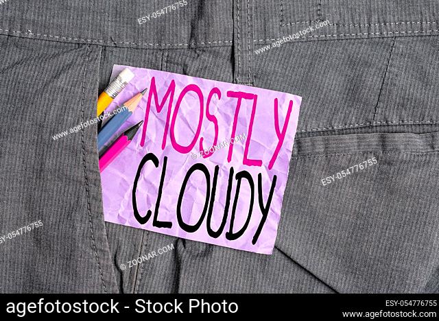 Conceptual hand writing showing Mostly Cloudy. Concept meaning Shadowy Vaporous Foggy Fluffy Nebulous Clouds Skyscape Writing equipment and purple note paper...