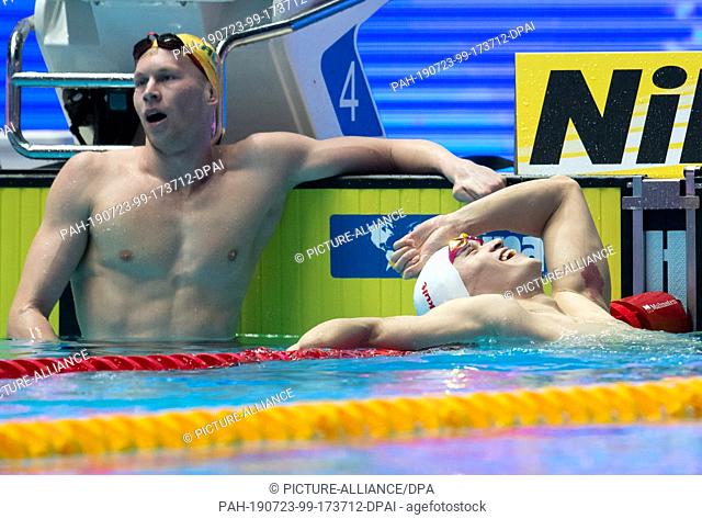23 July 2019, South Korea, Gwangju: South Korea, Gwangju: Swimming World Championship: 200 m freestyle, Men: Sun Yang from China (r) is happy about his victory...