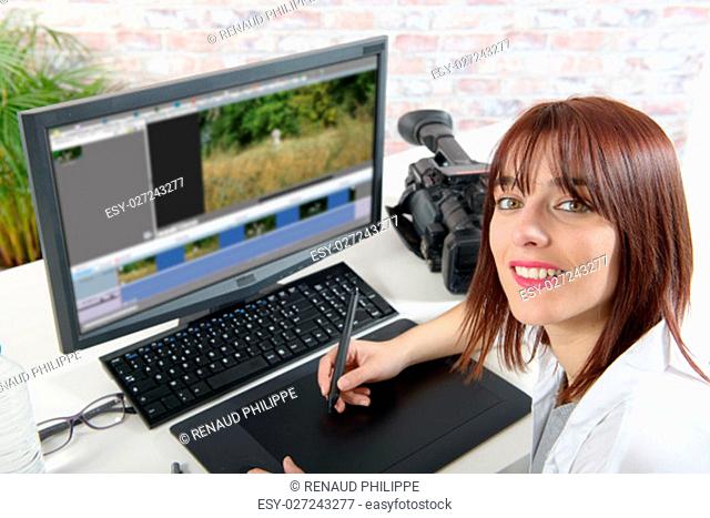 young smiling woman designer using computer for video editing