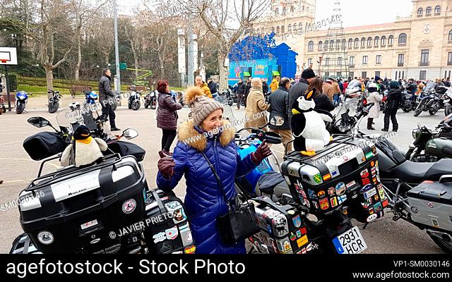 A middle-aged woman is pictured with two motorcycles with penguin pets during the 37th Edition of PINGÜINOS. Concentration of motorcyclists