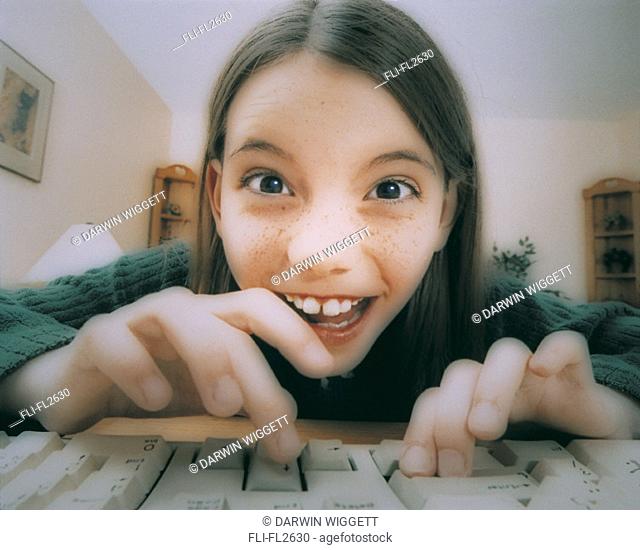 Girl playing on computer keyboard