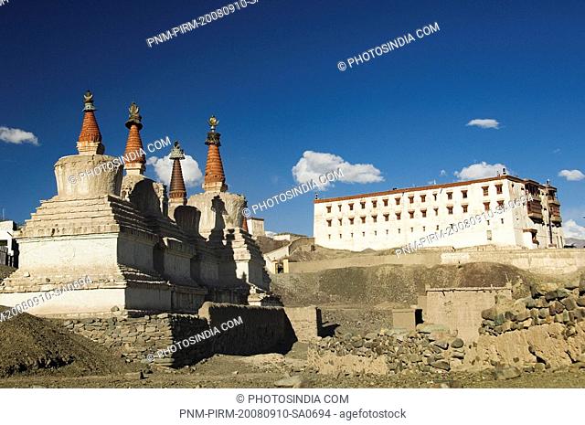 Chortens with a monastery in the background, Stok Monastery, Ladakh, Jammu and Kashmir, India
