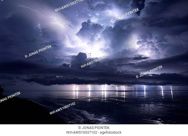 Lightshow of a thunderstorm with strong updrafts, ice caps and a developing shelf cloud above the lake Maracaibo (Catatumbo thunderstorm