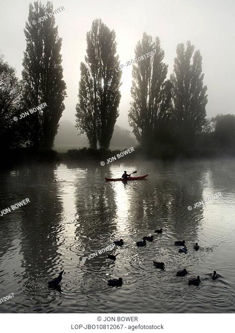 A rower on a misty morning near to Saint Helen's wharf in Abingdon on Thames