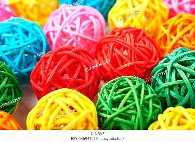 Surface covered with the multiple decorative and colored straw balls as an abstract background composition