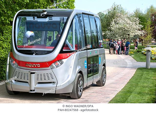 A completely self-driving Arma electric bus by French manufacturer Navya makes its way through the Park of the Gardens in Bad Zwischenahn, Germany, 10 May 2016