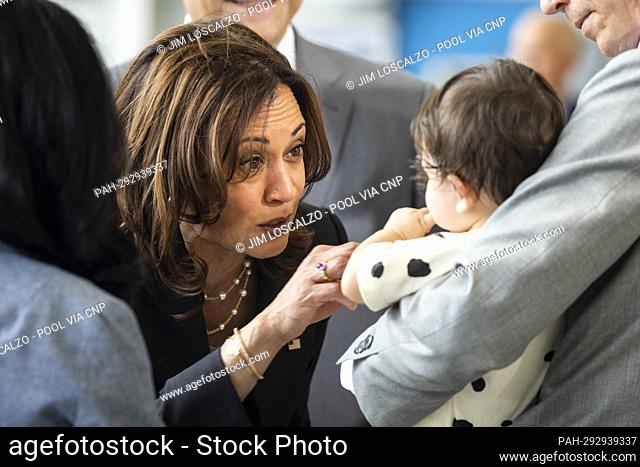 United States Vice President Kamala Harris (L) greets eight-month-old Manadana Marvel Metcalf (R) prior to speaking on Operation Fly Formula in front of a...