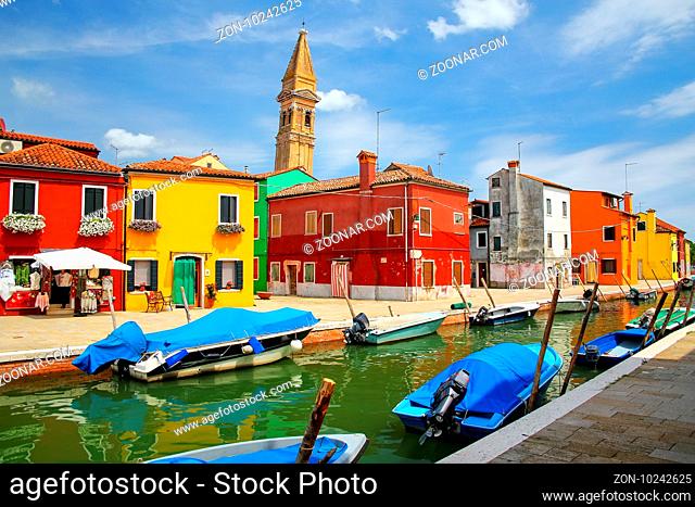 Colorful houses by canal in Burano, Venice, Italy. Burano is an island in the Venetian Lagoon and is known for its lace work and brightly colored homes