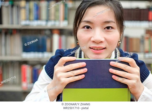 Student resting her chin on textbook