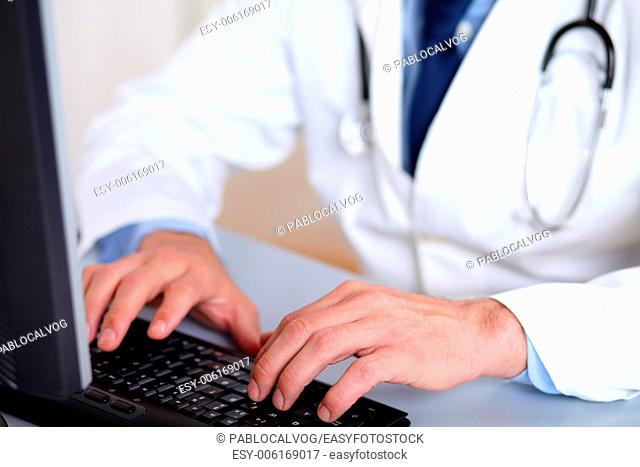 Portrait of professionals doctor hands working on computer