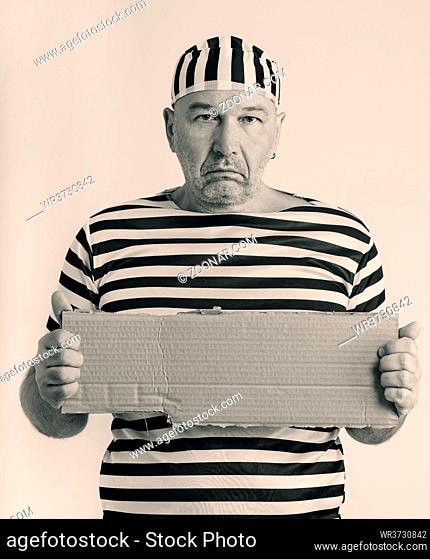 portrait of a man prisoner in prison garb in retro style