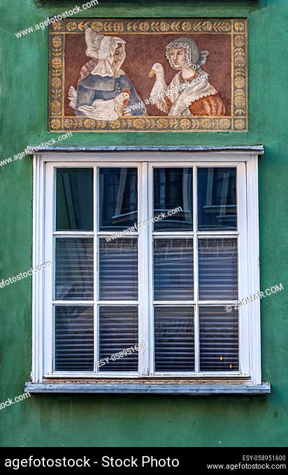 Window with decorations on the wall of renovated old tenement house in Gdansk Old Town, Poland