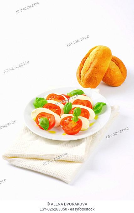 plate of caprese salad and fresh buns