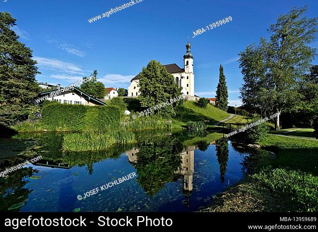 Germany, Bavaria, Upper Bavaria, Chiemgau, Breitbrunn, parish church of St. John the Baptist, village pond, mirroring