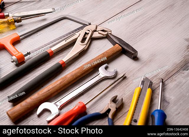 Screwdriver, hammer, tape measure and other tool for construction tools on gray wooden background, industry engineer tool concept.still-life
