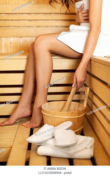 Woman relaxing and using sauna accessories Debica, Poland