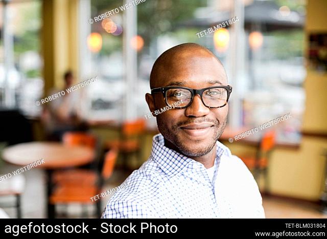 Black man smiling in coffee shop