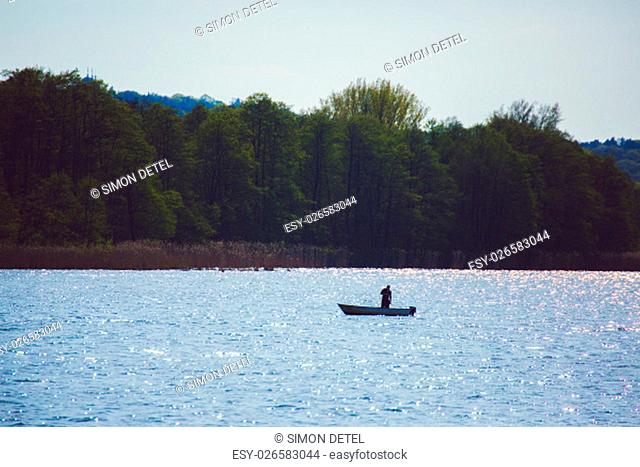 angler in small boat on mueggelsee Lake near berlin Germany