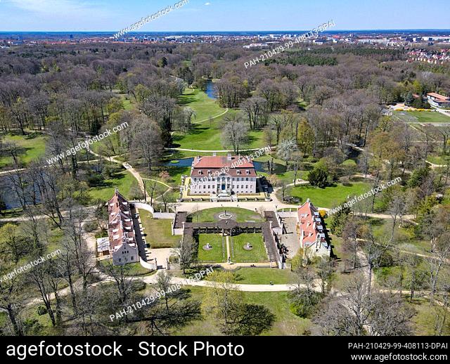 27 April 2021, Brandenburg, Cottbus: Sun shining over the Branitz Palace and Park of the Prince Pückler Museum Foundation (aerial photograph taken with a drone)