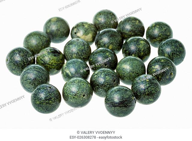 many beads from green serpentine gemstone on white background