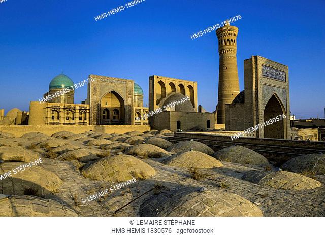 Uzbekistan, Silk Road, Bukhara, historical center listed as world heritage by UNESCO, Kalon Minaret and Mir I Arab Madrasah seen from the roof of the Kalon...