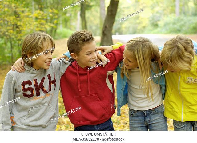 Children, boys, girl, cheerfully, arm in arm, laugh stands, outside, semi-portrait, friends, 8-12 years, four, group, friendship, fun, together, joy, affection