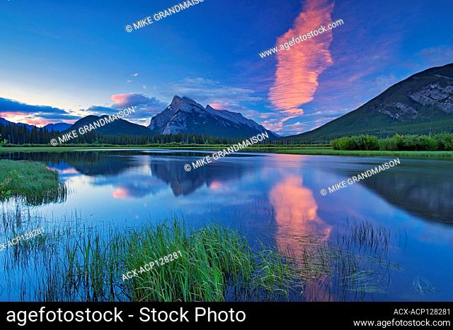 Cloud at dawn reflected in Vermillion Lakes with Mount Rundle . Banff National Park Alberta Canada