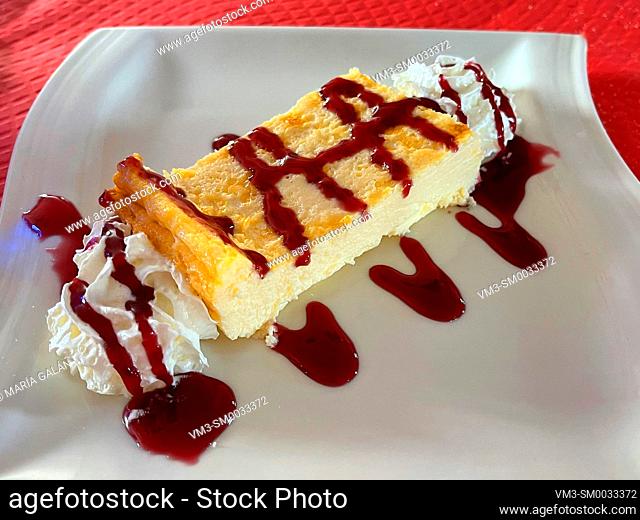 Cheese cake with cream and raspberry syrup