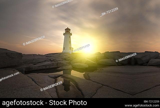 Lighthouse surrounded by rocks at sunset, lighthouse surrounded by rocks near the ocean