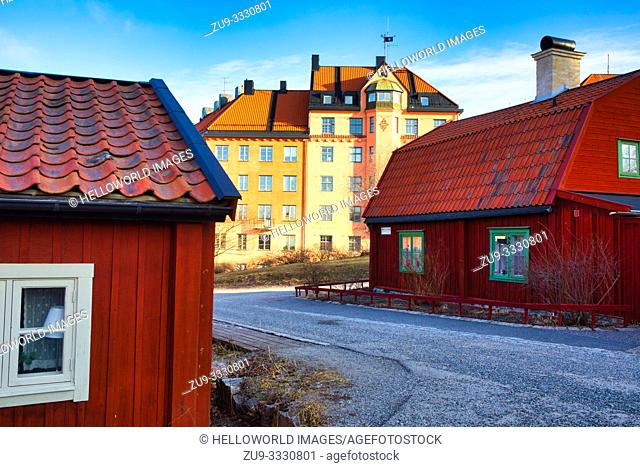 Typical wooden residential houses painted in traditional falun red in the cultural preserve of Vita Bergen (white mountain), Sodermalm, Stockholm, Sweden