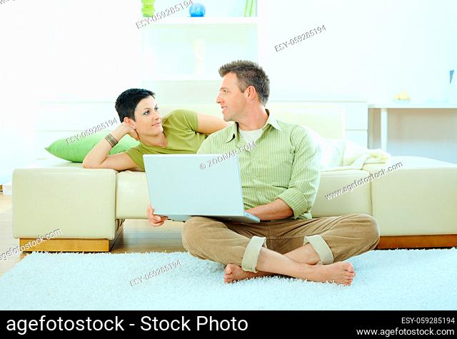 Couple using laptop computer at home