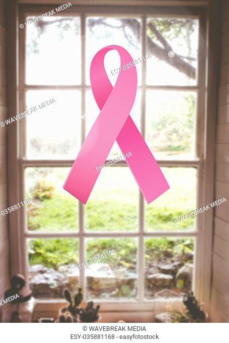 pink ribbon for breast cancer awareness over bright window background