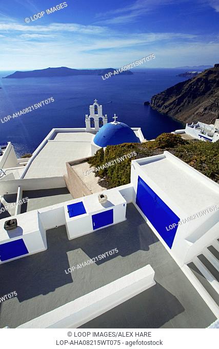 A view of a famous blue domed church with the caldera and sea beyond