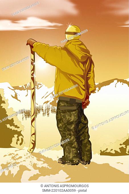 Man standing looking at view with his skis