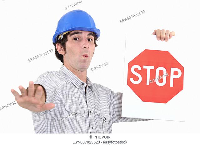 Worker holding a red stop sign