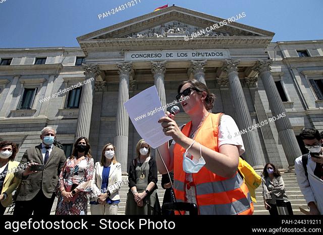 Madrid, Spain; 08/06/2021.- A worker reads the demands of the demonstration in front of Parliament to some representatives of political parties
