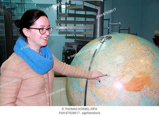 Nadja Tretjakowa, an English teacher who also works as a tour guide in the Kosmodrom Museum, shows the location of the town of Baikonur, Kazakhstan